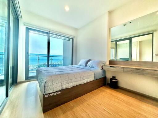 Bright and modern bedroom with ocean view and workstation