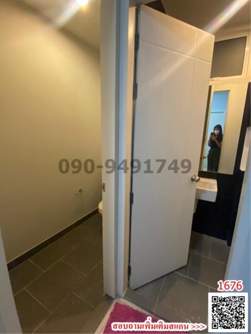 Compact bathroom with modern design and visible mirror reflection