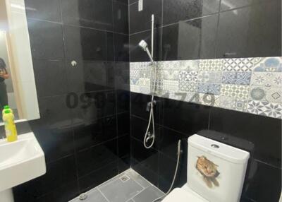 Modern bathroom with black tiles and stylish design