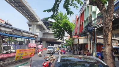 Busy urban street with public transportation and local shops