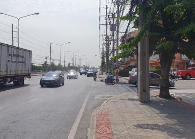 Busy urban street with vehicles and sidewalk