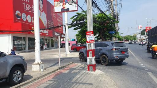 Urban street scene with commercial buildings and busy traffic