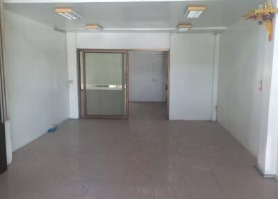 Spacious empty interior of a commercial building with large entrance doors