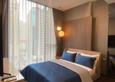 Modern bedroom with city view in high-rise apartment