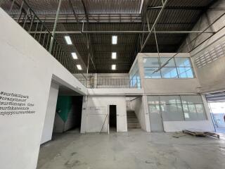 Spacious industrial building interior with high ceiling and multiple levels