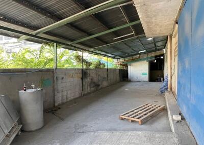 Spacious semi-covered storage area with concrete flooring
