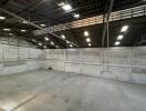 Spacious empty industrial warehouse interior with high ceiling