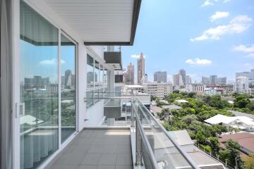 Spacious balcony with city view and clear sky