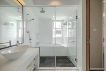 Modern bathroom with glass shower enclosure and white vanity