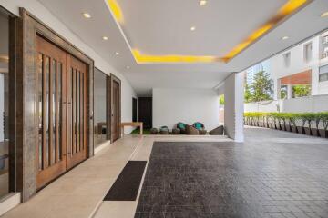 Modern lobby entrance of a residential building with sleek design and elegant lighting