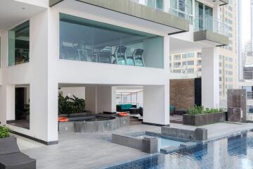 Modern residential building with outdoor pool and gym