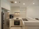 Modern kitchen with stainless steel appliances and white cabinets