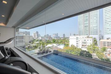 Luxurious indoor swimming pool with panoramic cityscape view