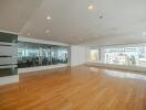 Spacious living room with hardwood flooring and city view