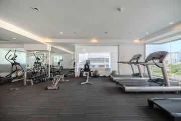 Modern gym facility in residential building with a variety of equipment