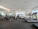 Modern gym facility in residential building with a variety of equipment