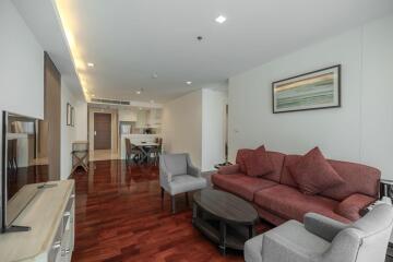 Spacious living room with integrated dining area and hardwood flooring