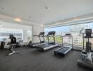 Modern high-rise apartment gym with treadmills and fitness equipment