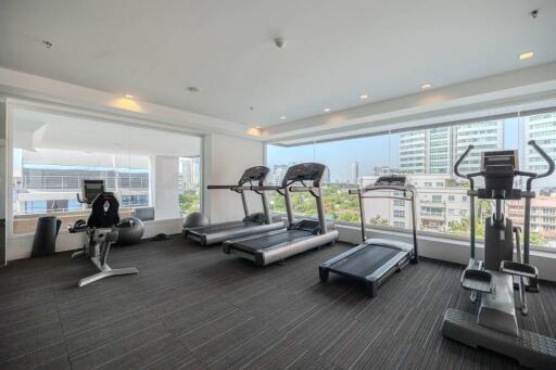 Modern high-rise apartment gym with treadmills and fitness equipment