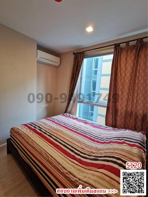 Cozy bedroom with large window and modern air conditioning unit