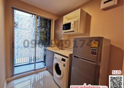 Compact modern kitchen with window, appliances and QR code advertisement