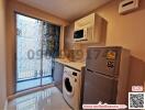 Compact modern kitchen with window, appliances and QR code advertisement