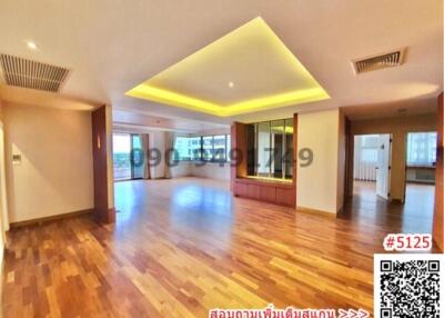 Spacious living room with hardwood floors and ambient lighting