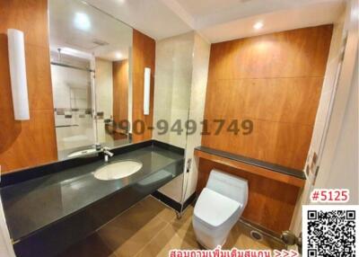 Modern bathroom with wooden paneling and spacious layout