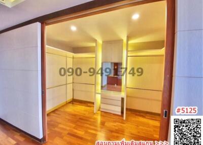Spacious bedroom with built-in wardrobes and wooden flooring