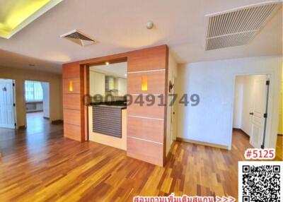 Spacious living room with wooden flooring and ample natural light