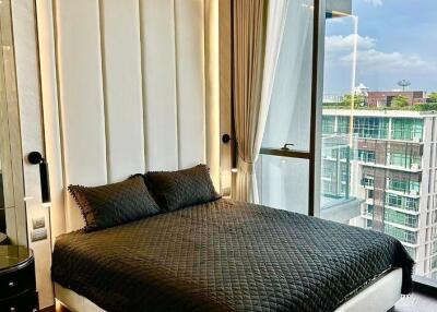 Modern bedroom with large windows overlooking the city