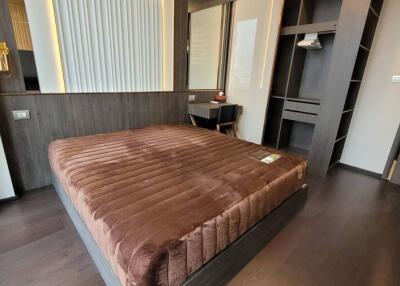 Modern bedroom with elegant dark wood finishes and brown bedding