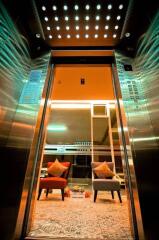 Modern elevator lobby with stylish chairs and decorative lighting