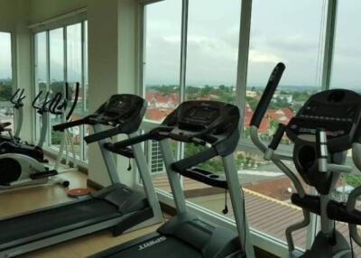 High-rise apartment building gym with treadmills overlooking the city