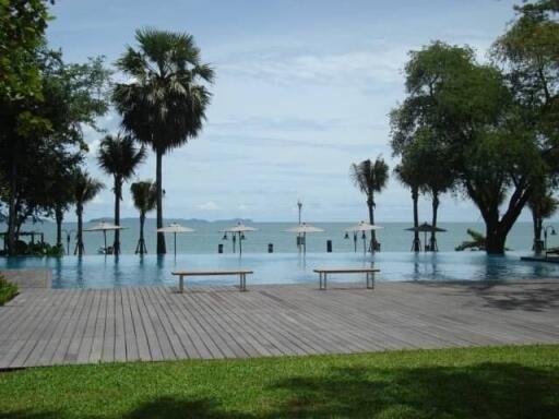 Luxurious poolside with ocean view and lush palm trees