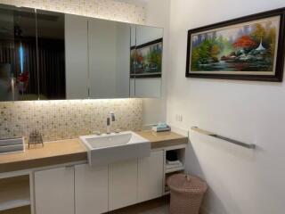 Modern kitchen with white cabinetry and a mosaic backsplash