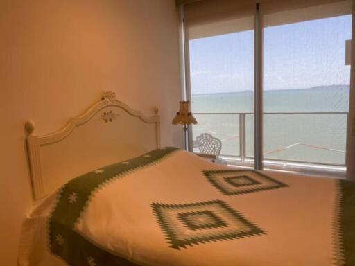 Cozy bedroom with a scenic ocean view and elegant decor