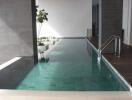 Modern residential indoor swimming pool with natural lighting