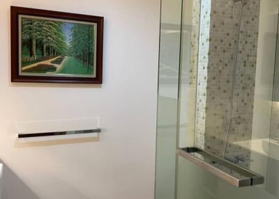 Modern bathroom with glass shower and framed artwork