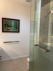 Modern bathroom with glass shower and framed artwork