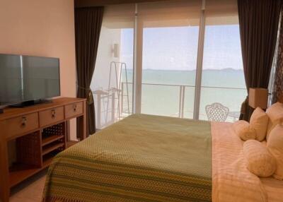 Spacious bedroom with large windows overlooking the sea