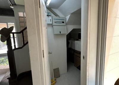 Interior view of a small utility room with sloped ceiling and natural light
