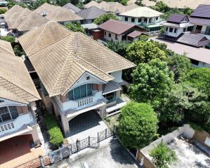 Aerial view of a detached residential house with tiled roofing
