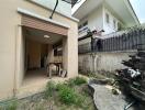 Exterior view of a home featuring side entrance and garden area