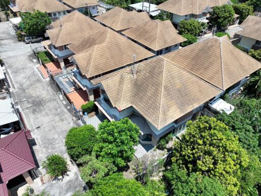 Aerial view of a residential neighborhood showing rooftops and surrounding greenery