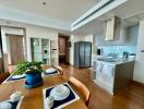 Spacious modern kitchen and dining area with wooden flooring and contemporary appliances