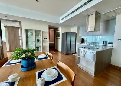 Spacious modern kitchen and dining area with wooden flooring and contemporary appliances
