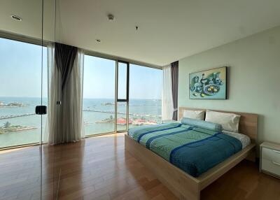 Modern bedroom overlooking the sea with large windows