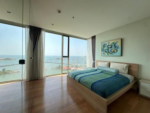 Modern bedroom overlooking the sea with large windows