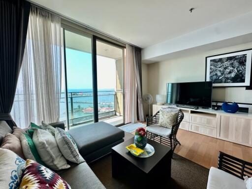 Bright and cozy living room with balcony access showing ocean view